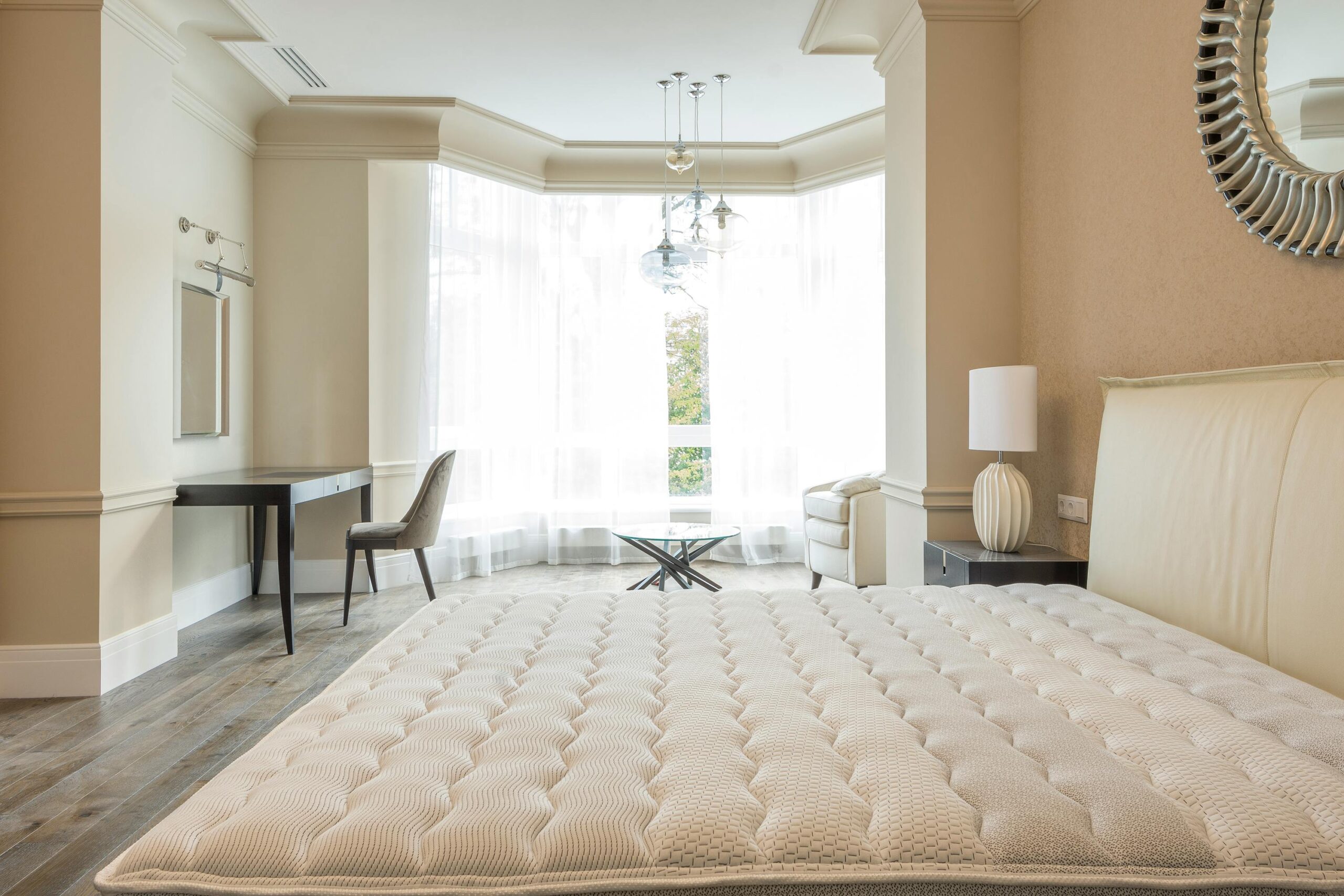 Elegant spacious bedroom with modern furniture, featuring large windows and abundant natural light.